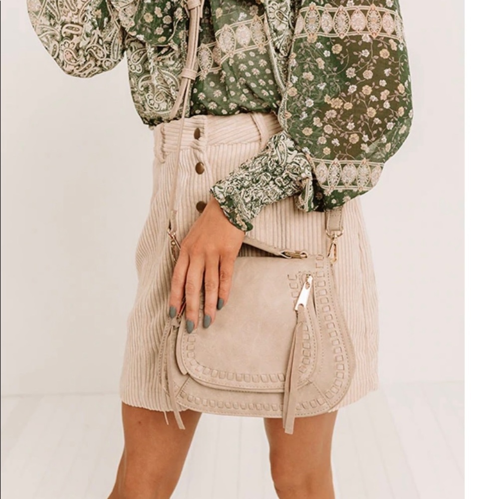 crossbody purse in beige/cream color.